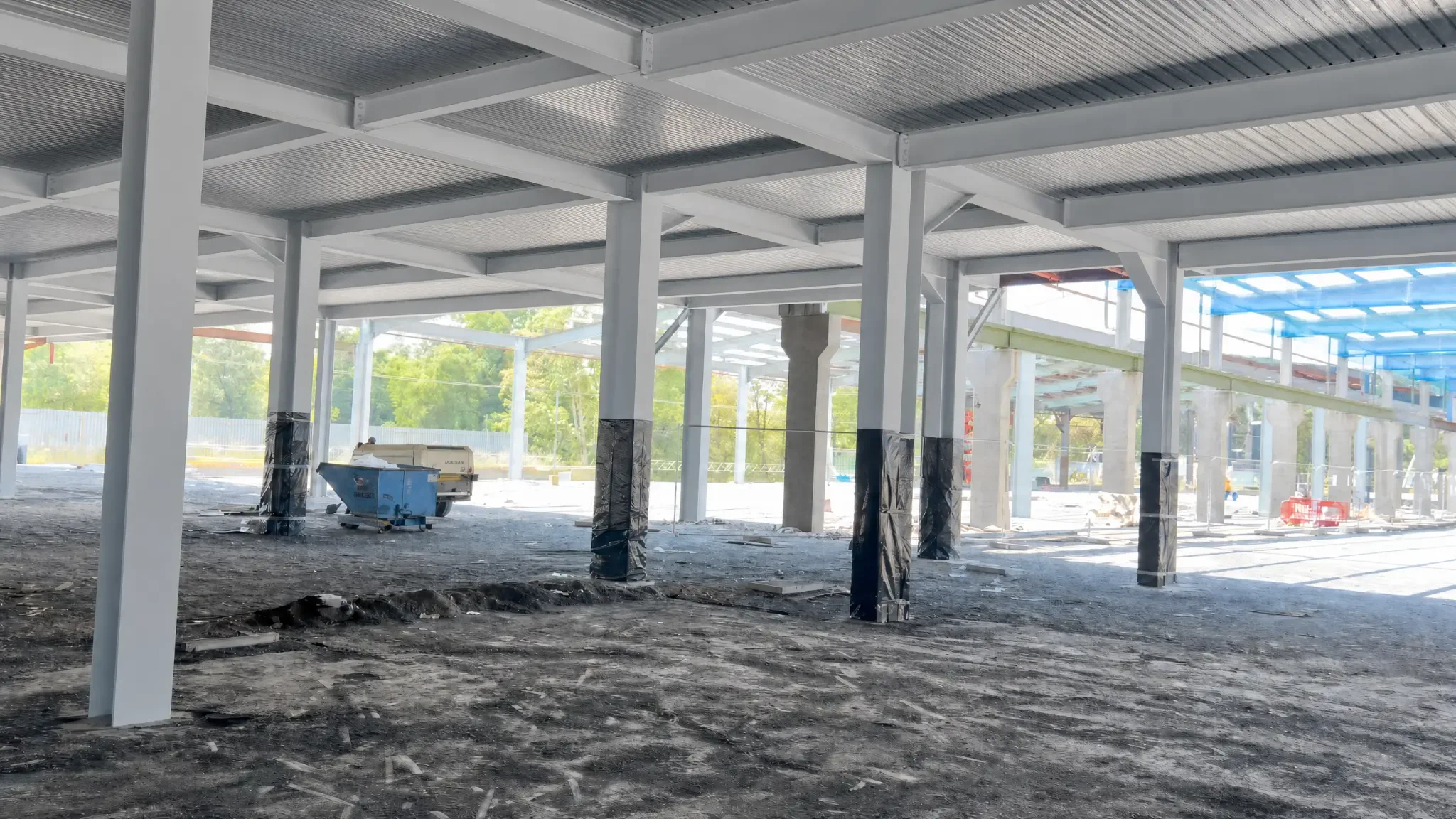 Intumescent painting Croydon: coated steelwork and elevated access within a large framed building, shown as a Premier Blasting project example