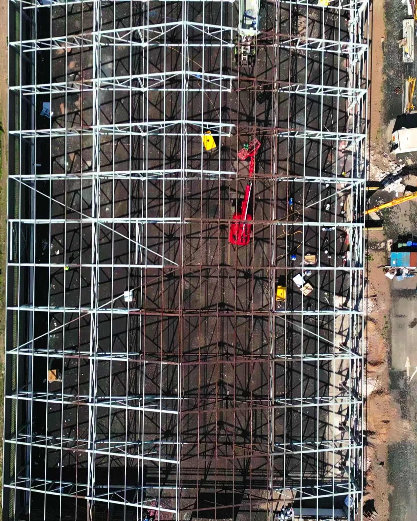 Portrait aerial project view of structural steelwork and site activity.